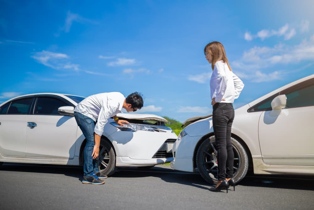 Two motorists engaged in a heated dispute following a collision on the roadway.