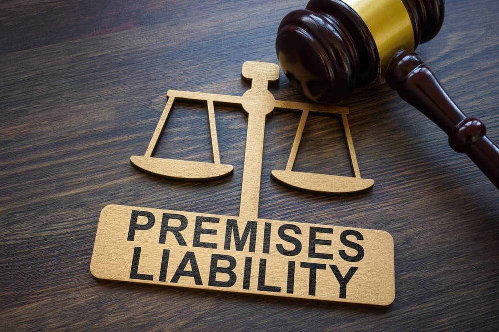 A plate bearing the words "Premises Liability" sits alongside a gavel, evoking the concept of legal responsibility within a property setting.