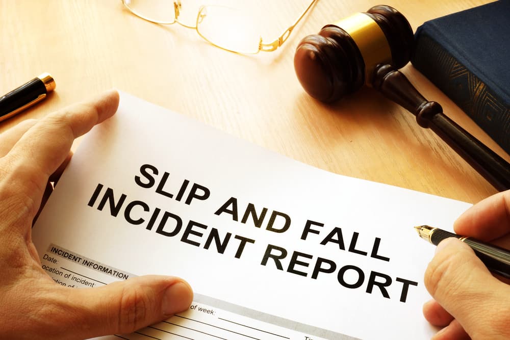 A slip and fall injury report placed neatly on a table, detailing the incident and its aftermath.