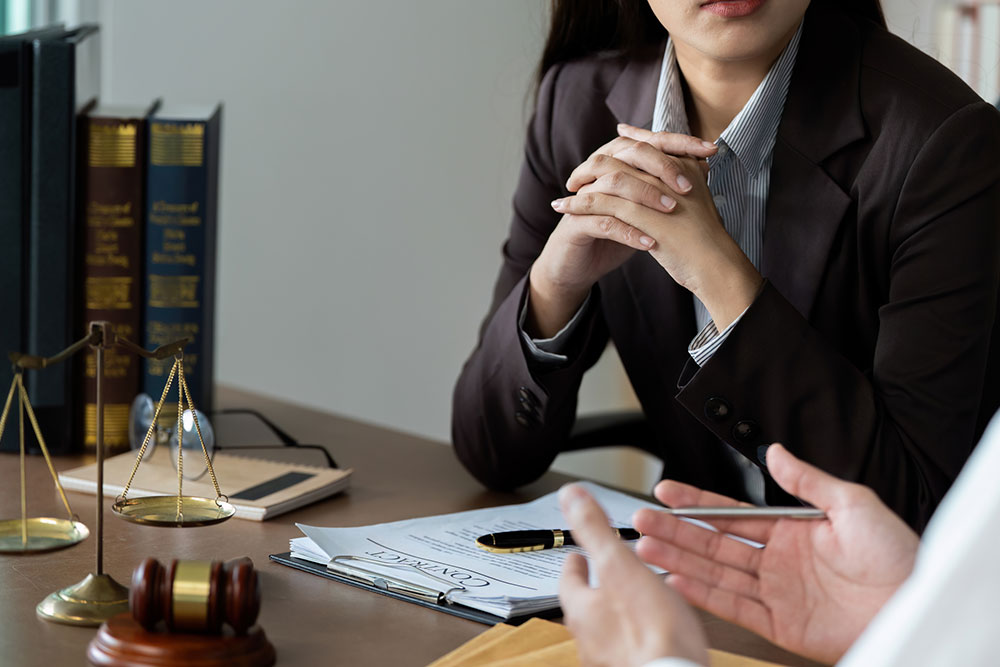 Professional legal meeting with a lawyer explaining contract terms, representing a free consultation and how contingency fee agreements work